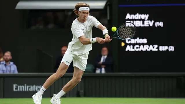 Andrey Rublev plays a backhand