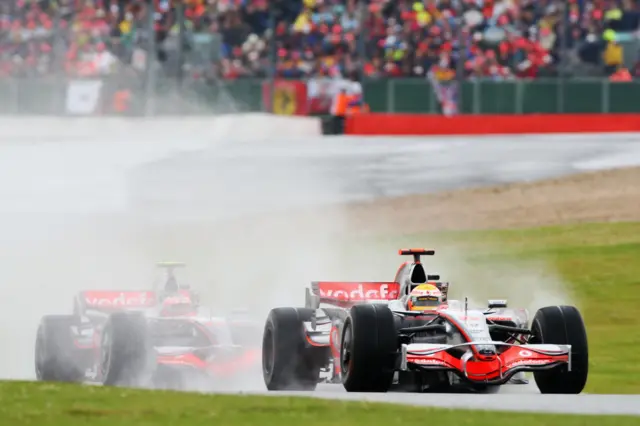 McLaren's Lewis Hamilton leads team-mate Heikki Kovalainen in wet conditions at the 2008 British Grand Prix