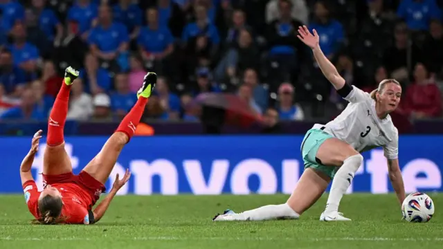 Switzerland's defender #05 Noelle Maritz and Iceland's forward #03 Sandra Jessen crash to the ground