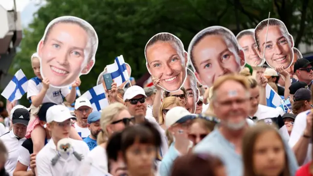 Fans of Finland enjoy the pre-match atmosphere while holding card board cut outs of players prior to the UEFA Women's EURO 2025 Group A match between Norway and Finland at Stade de Tourbillon