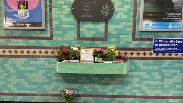 Flowers left under plaque
