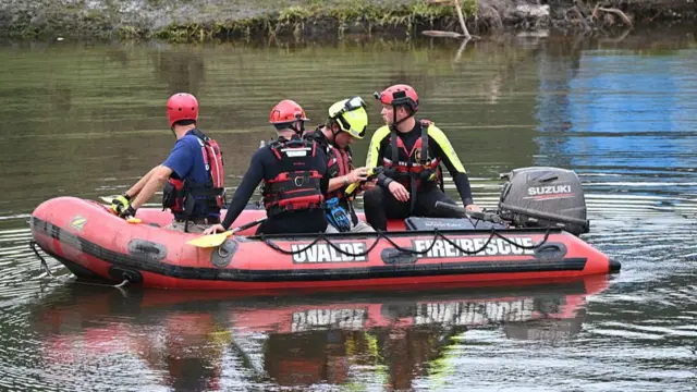 A red boat carrying a search and rescue team
