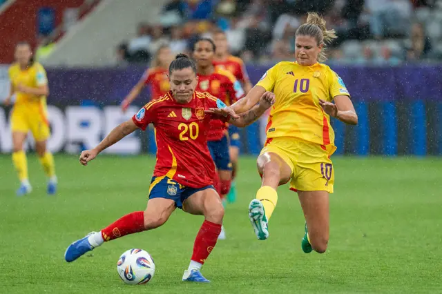 Claudia Pina of Spain (L) takes a shot under pressure from Justine Vanhaevermaet of Belgium