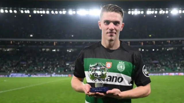 Viktor Gyokeres holding Champions League player of the match trophy