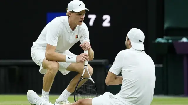 Jannik Sinner crouches down to injured Grigor Dimitrov