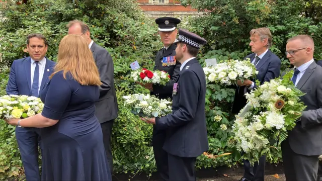 Emergency Services at Tavistock Square holding wreaths
