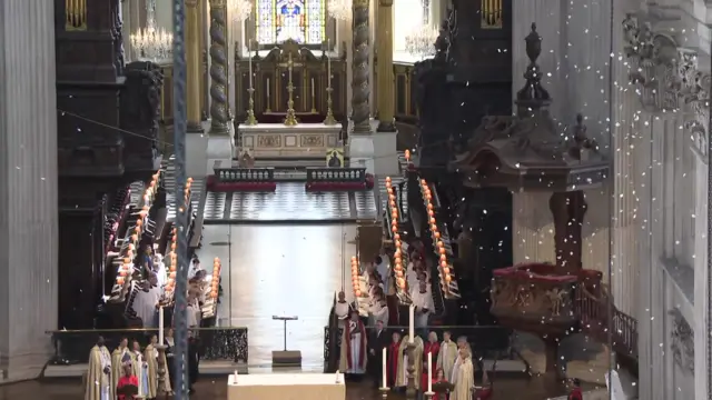 White pieces of paper falls from the ceiling of St Paul's Cathedral
