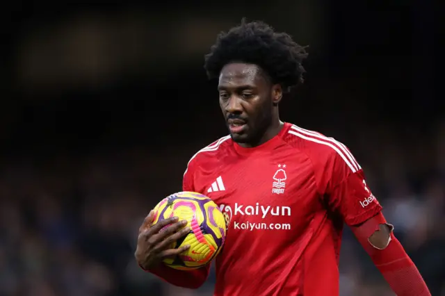 Ola Aina holding a football