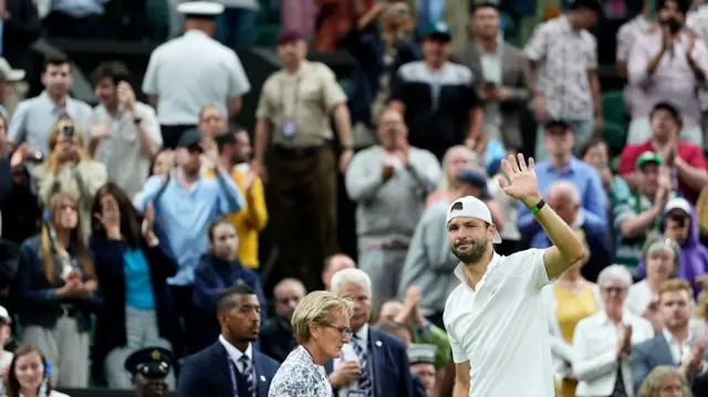 Grigor Dimitrov gestures to the crowd