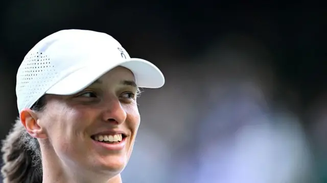 Iga Swiatek smiles after winning