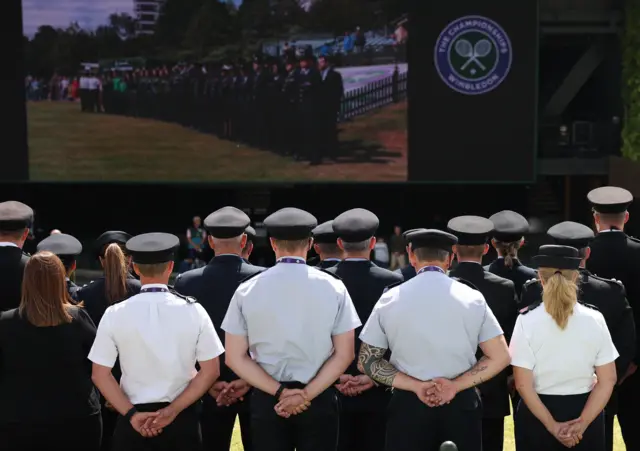Emergency personnel mark minute's silence