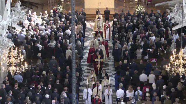 People file out of St Paul's Cathedral after a memorial service ends.