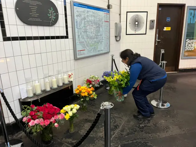 TfL staff member lays flowers at Edgware Road