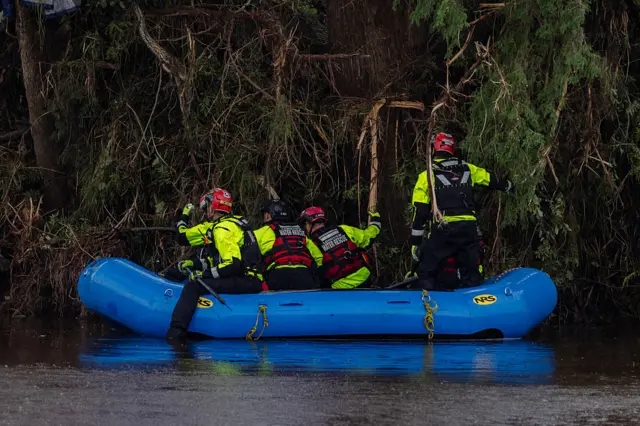 Search and recovery workers on a boat looking for survivors