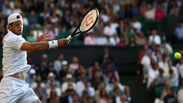 Grigor Dimitrov plays a forehand return