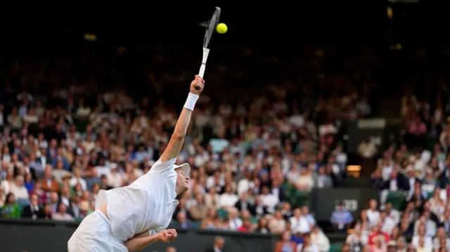 Jannik Sinner serves