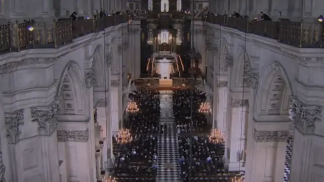 An aerial view of St Paul's show people seated in pews