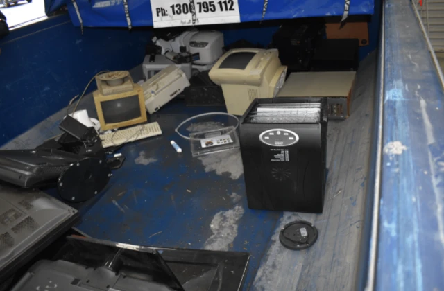 An image of a dehydrator inside a storage continaer next to old 1980s/1990s white computers