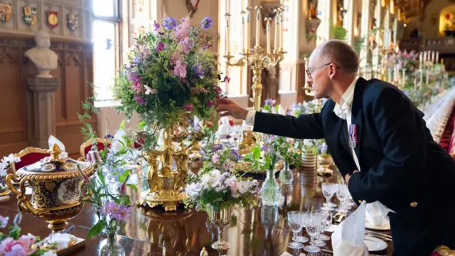 Flowers being arranged on the state banquet table