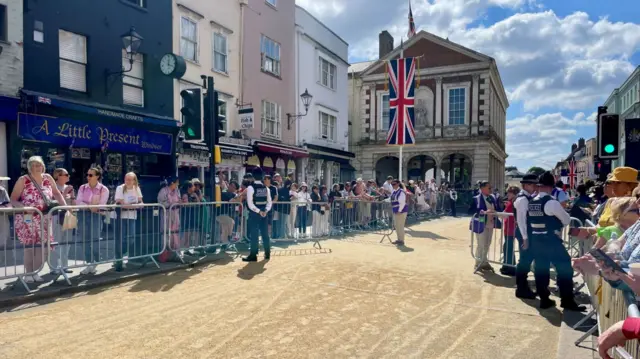 Crowds line one of the main roads through Windsor