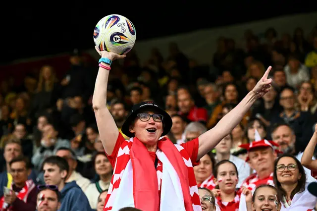A poland fan catches a ball in the warm up
