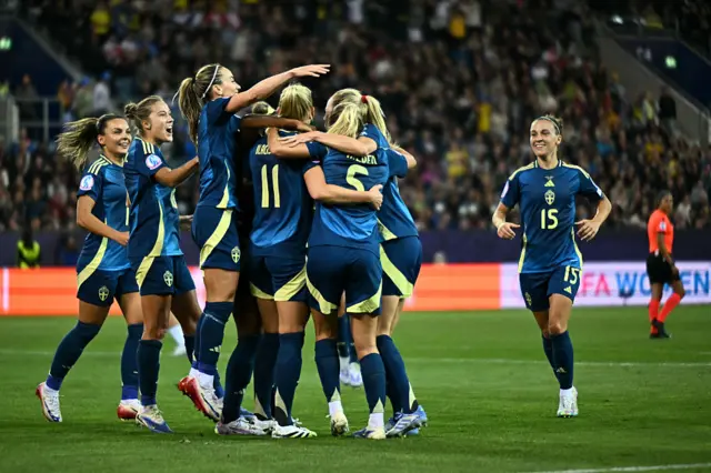 Sweden's players celebrate after scoring their first goal