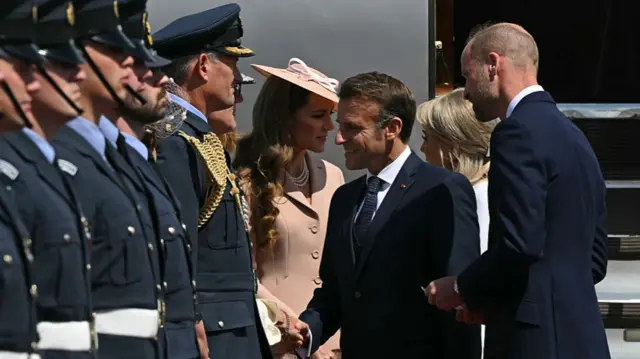 Macron greets royal family as he arrives at RAF Northolt.