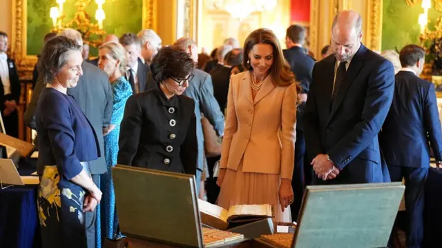 The Prince and Princess of Wales view items on display during the President of France Emmanuel Macron and his wife's visit to the Royal Collection exhibition.