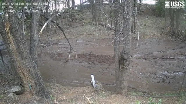 River Ruidoso, significantly higher, surrounded by trees