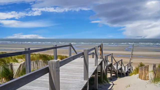 Wooden crossover passage over the dunes to the beach at the beach in Nieuwpoort, West Flanders, Belgium