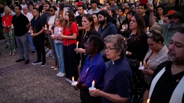 People holding candles take part in a vigil in memory of Texas flooding victims, at Travis Park in San Antonio