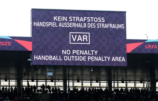 The LED board shows the VAR decision of no penalty