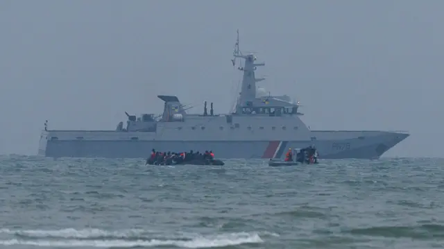 A Maritime Gendarmerie rib approaches a small boat full of migrants heading in to the English Channel.
