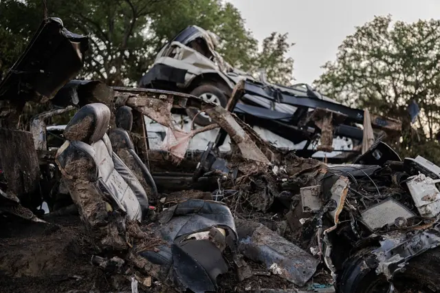 Debris lays along the Guadalupe River after it was swept up in the flash flooding