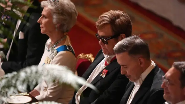 Elton John sitting next to David Furnish