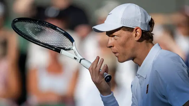 Jannik Sinner prepares to serve