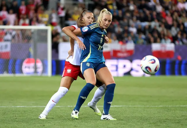 Emilia Szymczak of Poland and Stina Blackstenius of Sweden compete for the ball