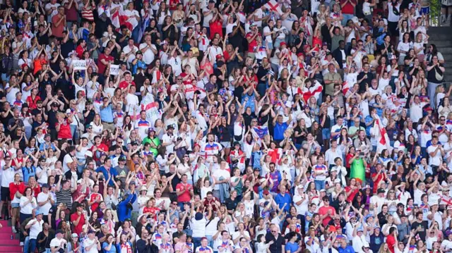 Fans of England celebrate the first team goal scored by Lauren James