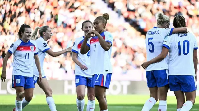 England's forward #07 Lauren James celebrates with teammates after scoring the third goal of the match
