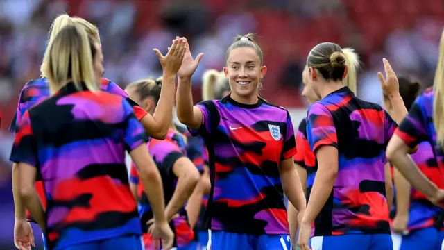 Maya Le Tissier of England high fives her teammates during the pre-match warm up