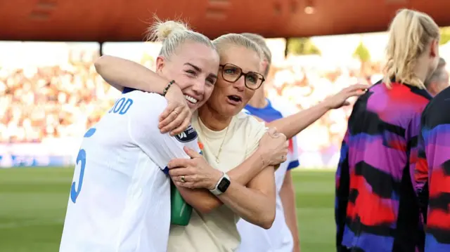 Sarina Wiegman, Head Coach of England, and Alex Greenwood of England embrace at full-time