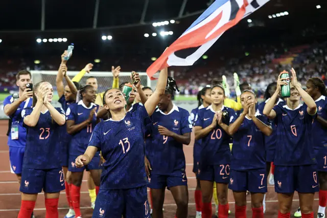 France celebrating by waving the French flag