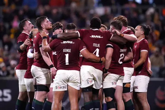 Lions squad in a huddle