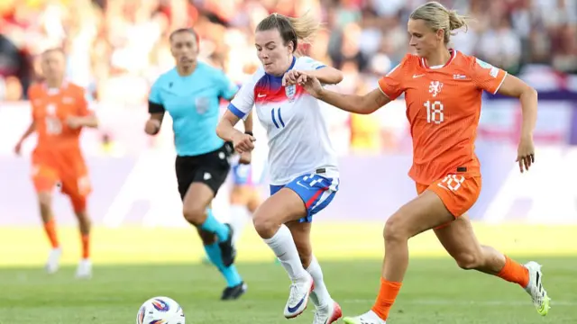 Lauren Hemp of England battles for possession with Kerstin Casparij of the Netherlands