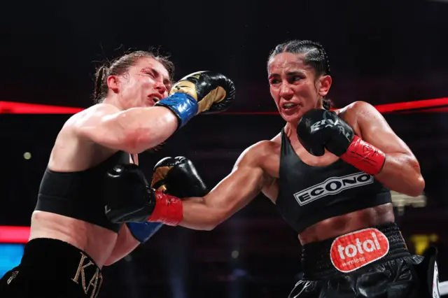 Amanda Serrano landing a body shot on Katie Taylor