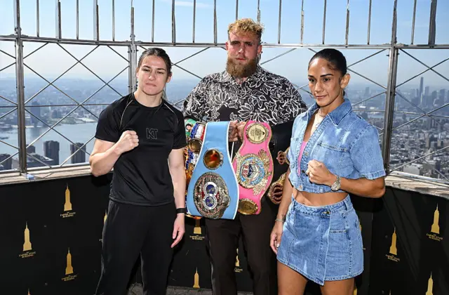 Katie Taylor, Jake Paul and Amanda Serrano posing with the belts