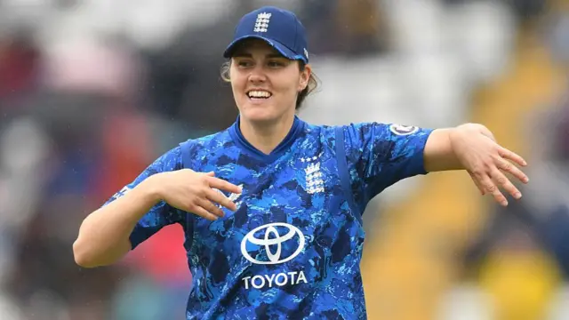 Nat Sciver-Brunt smiles as she leaves the field
