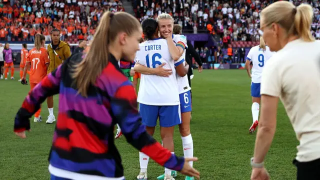Jessica Carter and Leah Williamson of England embrace following the team's victory