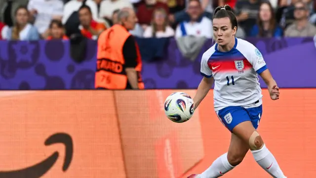 England's forward #11 Lauren Hemp plays the ball