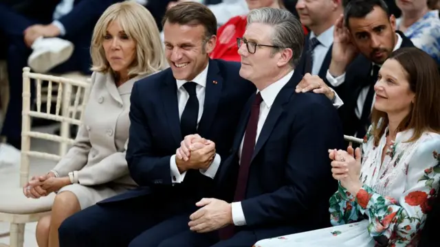 Starmer and Macron shake hands enthusiastically
